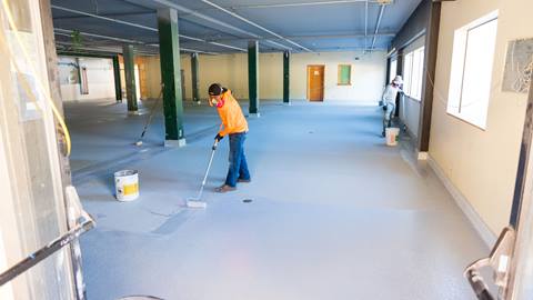 construction staff working on the new floors remodel inside of snow valley's rental shop